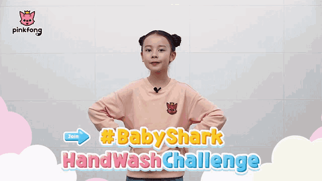 a little girl is standing in front of a sign that says baby shark hand wash challenge