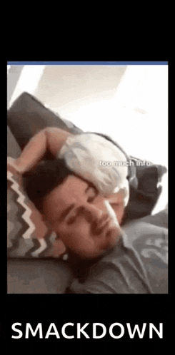 a man is sleeping with a baby on his head .