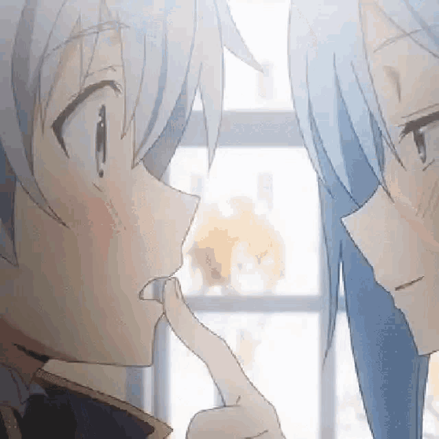 a boy and a girl are looking at each other and touching their faces with their fingers .