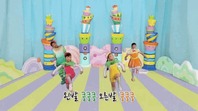 a group of children are dancing in a room with a blue background