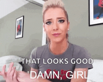 a woman is sitting on a bed making a funny face and saying `` that looks good damn , girl '' .