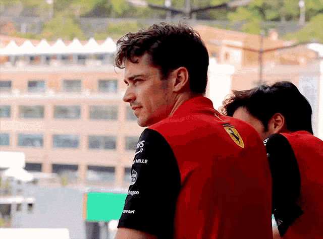 a man wearing a red shirt with the word mille on the back