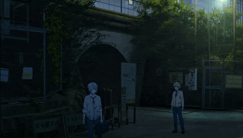 two people standing in front of a fence with a sign on it that says ' tokyo '