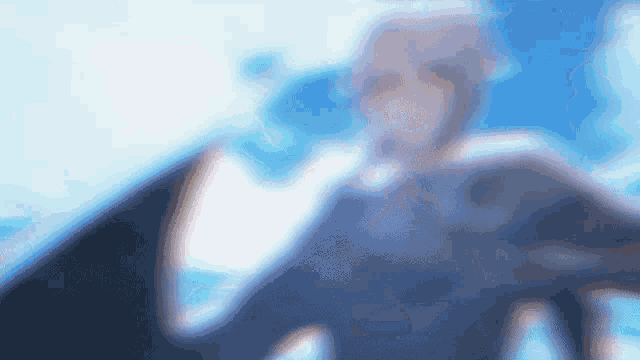 a blurry picture of a person with a blue background .