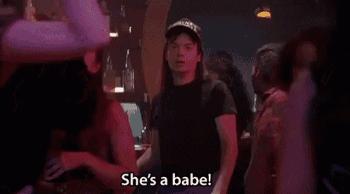 a man wearing a hat is dancing in a bar with a woman .