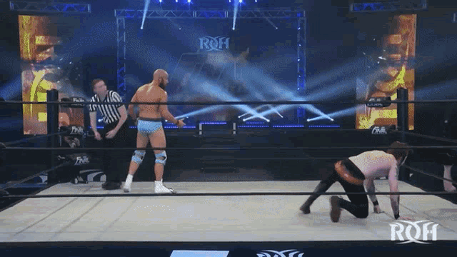 a wrestler in a ring with the word roh on the wall