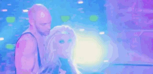 a drag queen is being held by a man in a blue outfit .