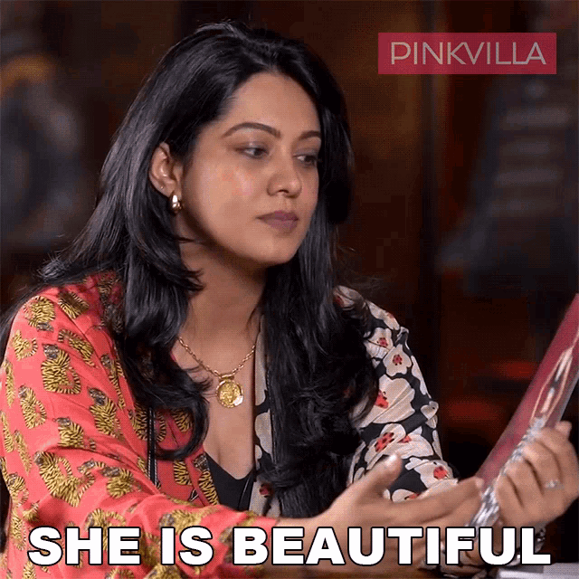 a woman is holding a picture and says she is beautiful on the bottom