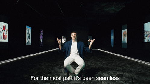 a man is sitting in a dark room with the words for the most part it 's been seamless