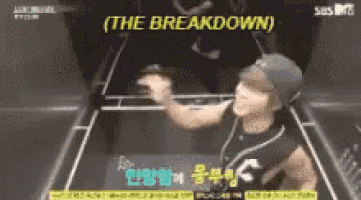 a man is playing a video game with the words `` the breakdown '' written on it .