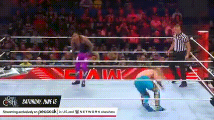 a wrestler is kneeling down in a wrestling ring in front of a referee .