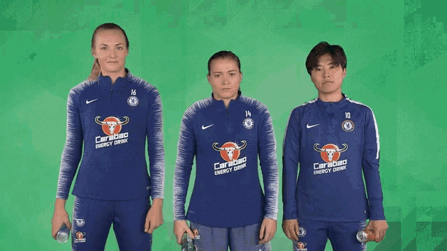 three people wearing blue shirts with caribou energy drink written on them
