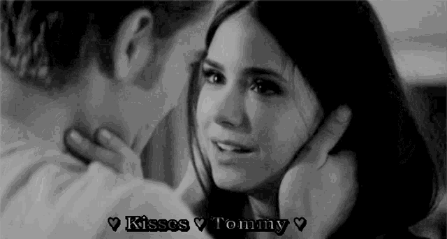 a black and white photo of a man kissing a woman with the words kisses tommy written on the bottom