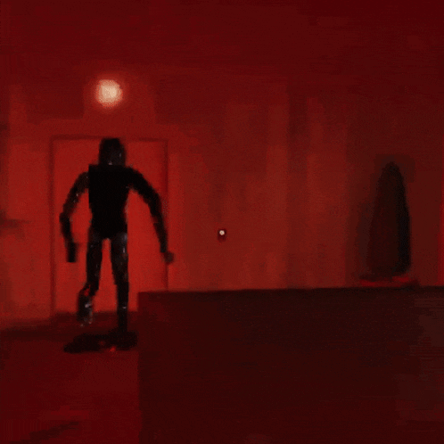 a silhouette of a person holding a gun in a dark room with red eyes .