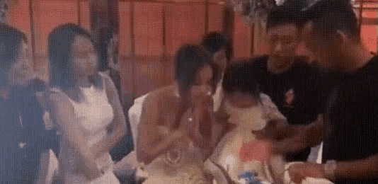 a group of people are sitting at a table in a restaurant .
