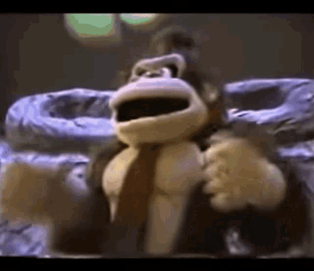 a stuffed donkey kong monkey is sitting on top of a trash can .