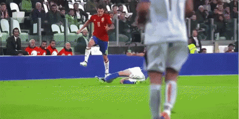 a soccer player with the number 11 on his jersey is kicking a ball
