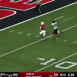a football player with the number 21 on his jersey is running on a field