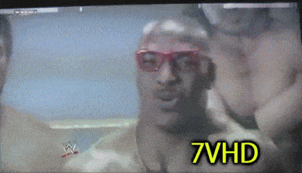 a tv screen shows a man wearing red glasses and the words 7vhd