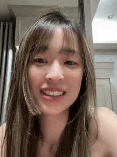 a close up of a woman 's face with a smile on her face