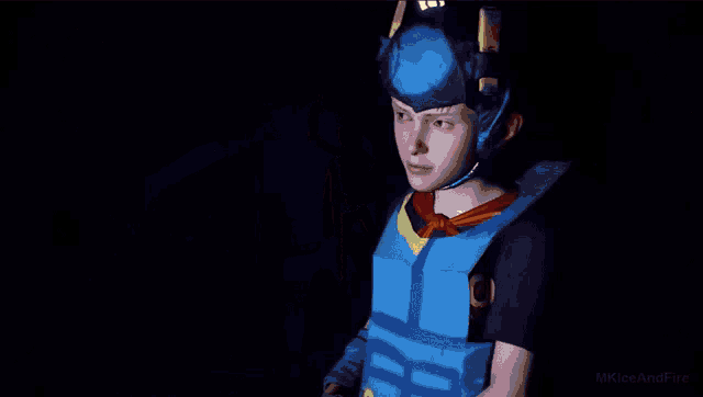 a boy in a blue and white outfit is pointing at a flame
