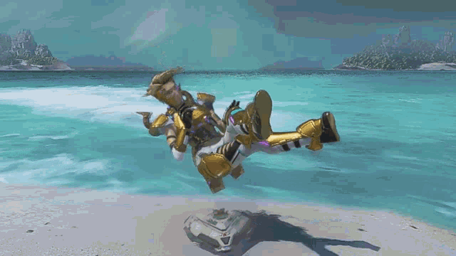 a person is falling into the water on a beach .