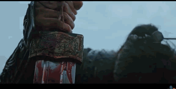 a person is holding a bloody sword in their hands