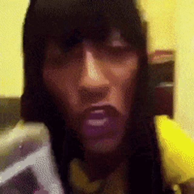 a blurry picture of a person 's face with a yellow background