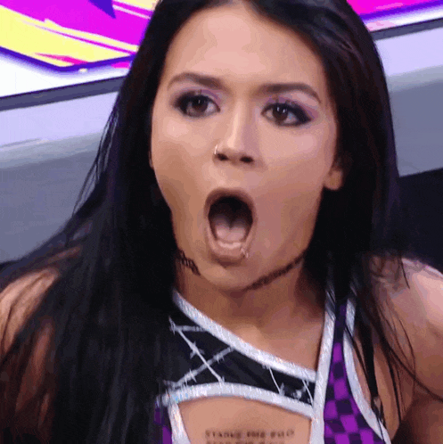 a woman with her mouth open has a tattoo on her chest that says ' stark pro '