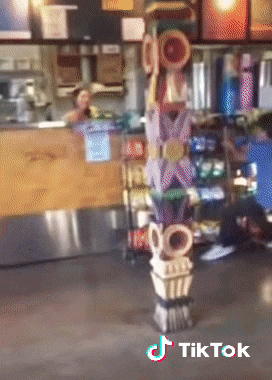 a tiktok video of a totem pole in front of a counter