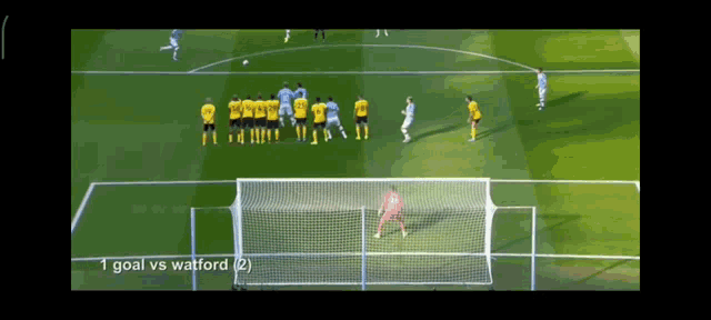 a soccer game is being played and the goal is 1 goal vs watford 2