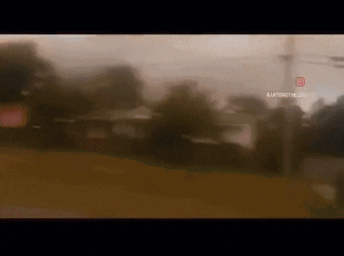 a blurry picture of a street with a stop sign in the middle
