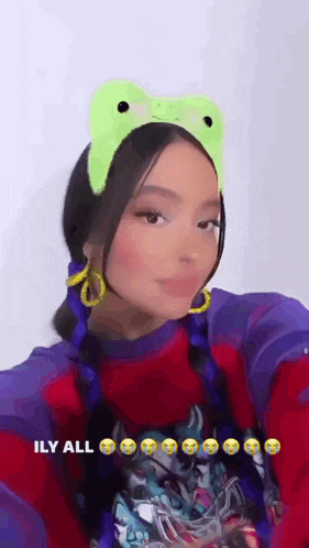 a woman wearing a frog headband and earrings .