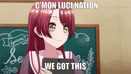 a girl with red hair is holding a tablet in front of a blackboard that says c mon luci nation