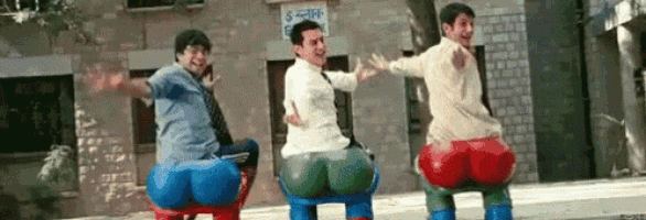 three men are riding balloons on a seesaw in a playground .