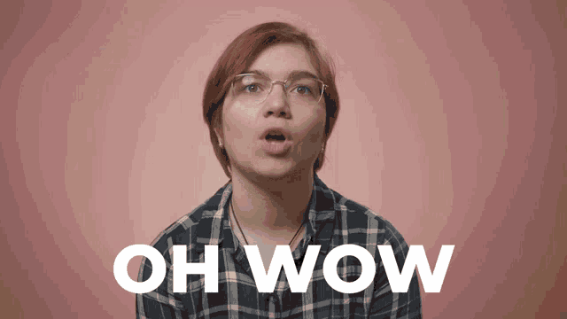 a woman wearing glasses and a plaid shirt says " oh wow "