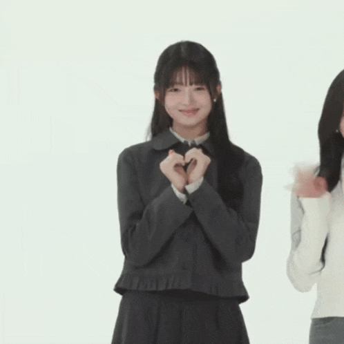 a girl in a school uniform is smiling and dancing