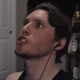 a man wearing headphones is making a funny face while looking up .