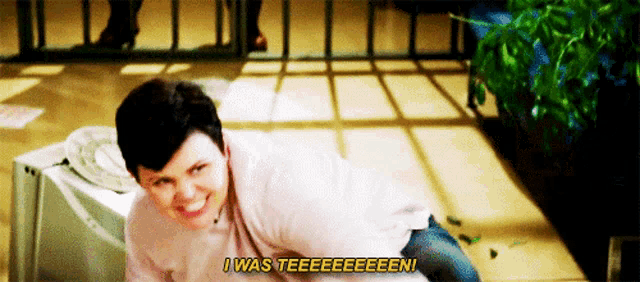 a woman is laying on the floor smiling and saying i was teeeeeeen .