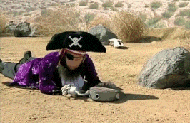 a person in a pirate costume is laying in the dirt