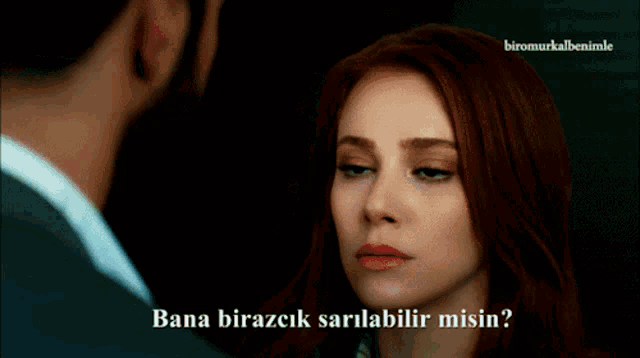 a man with a beard is talking to a woman with the words bana birazcik sarilabilir misin on the bottom