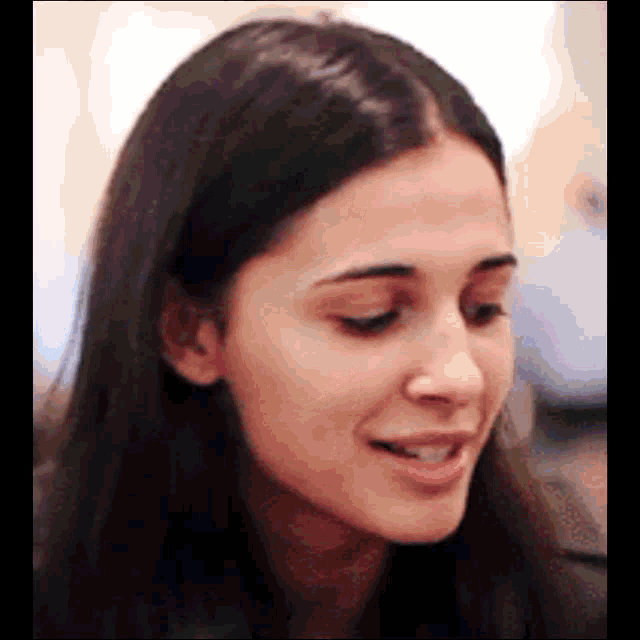 a close up of a woman 's face with a smile on her face and her mouth open .