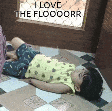 a child is laying on the floor with the words " i love the floooorr " written above him