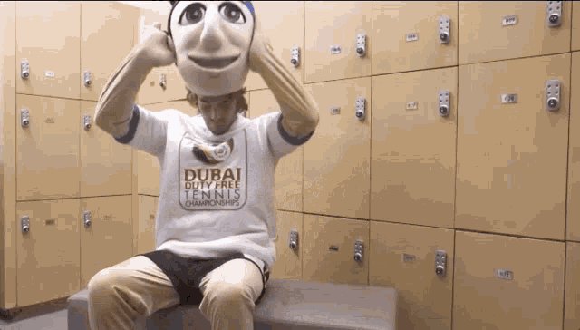 a man wearing a dubai duty free tennis championships shirt