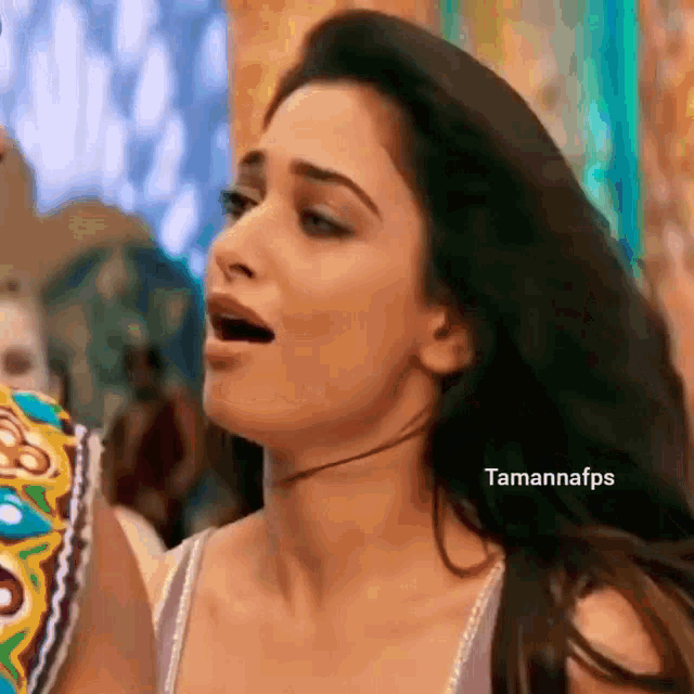 a woman is making a funny face with her mouth open .