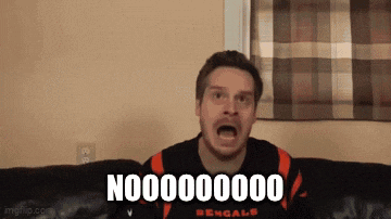 a man wearing a bengals jersey is sitting on a couch