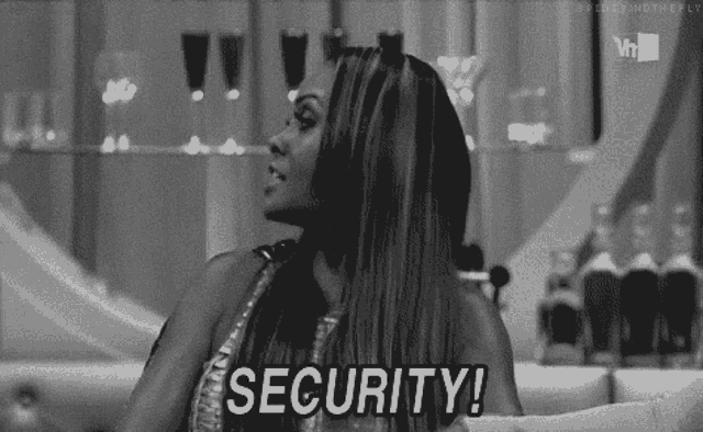 a black and white photo of a woman sitting on a couch saying security