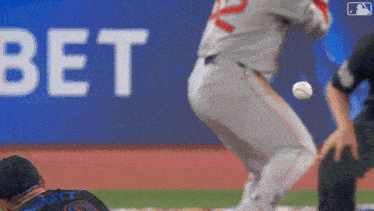 a baseball player is getting ready to throw the ball while another player watches .