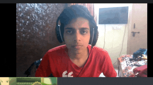 a young man wearing headphones and a red shirt that says fc on it
