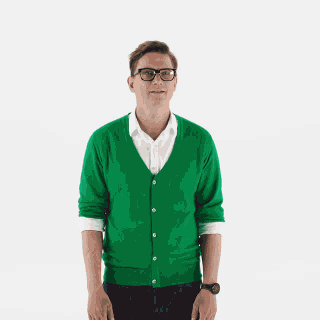 a man wearing glasses and a green cardigan